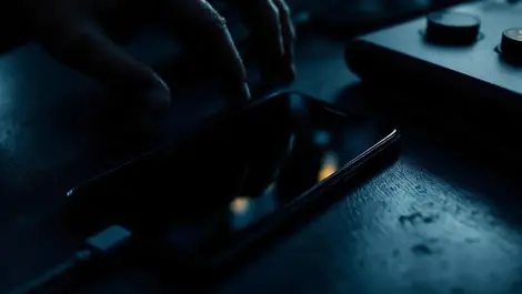 Dark moody android phone usb shadowy hand crypto security scene
